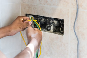 Series of electrician install and mount electrical power socket onto wall of residential home